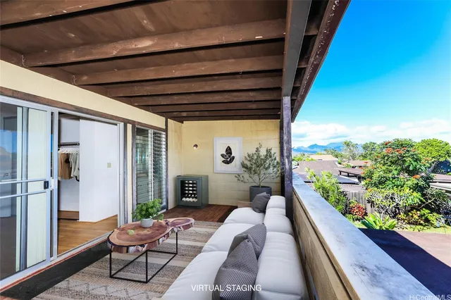 a balcony with furniture and a potted plant