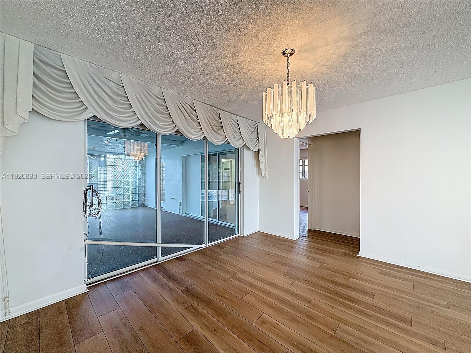 7541 Embassy Boulevard Miramar, FL 33023 - Photo 13 of 60 a view of empty room with wooden floor and fan