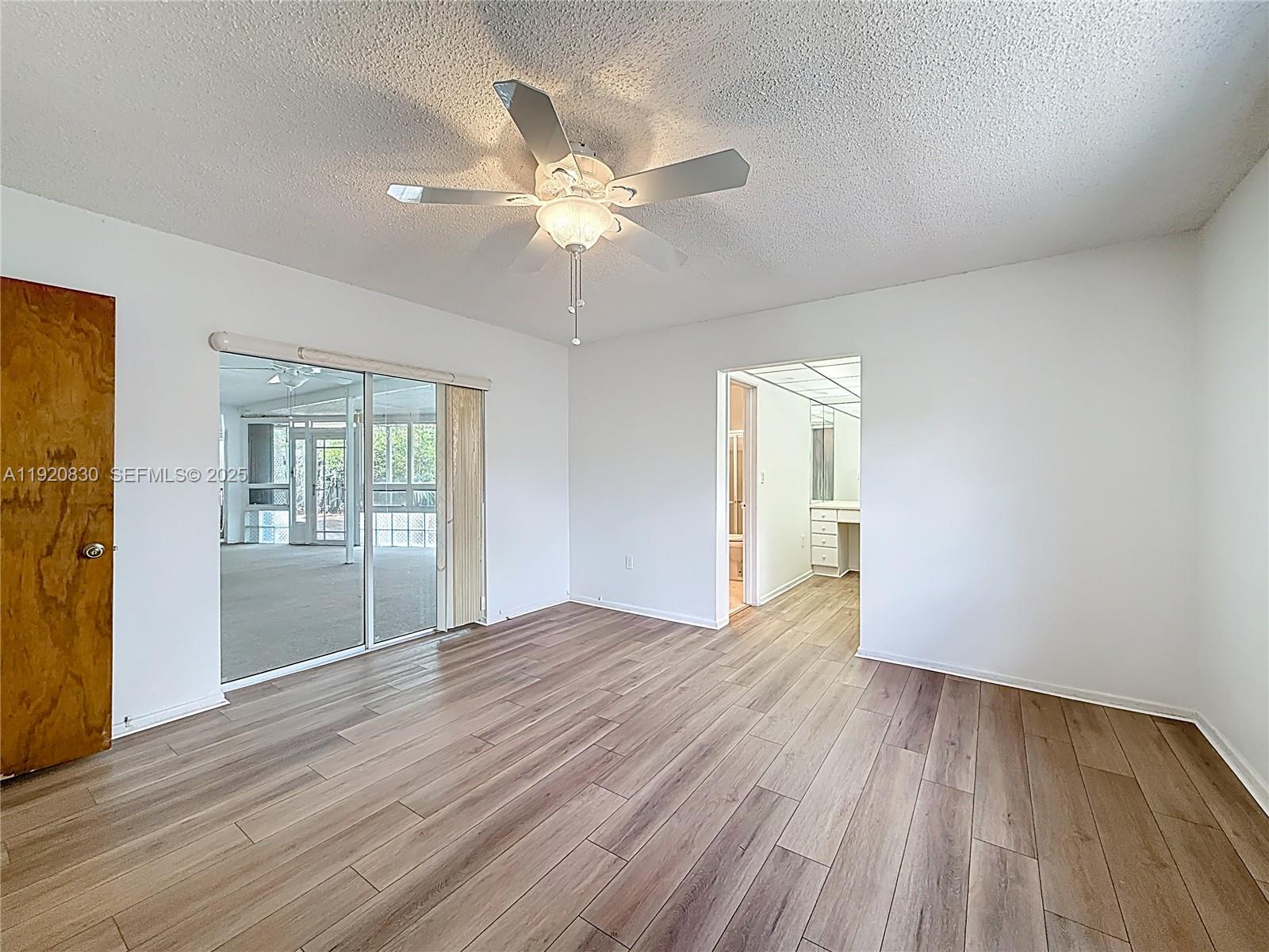 7541 Embassy Boulevard Miramar, FL 33023 - Photo 25 of 60 a view of an empty room with wooden floor and a window