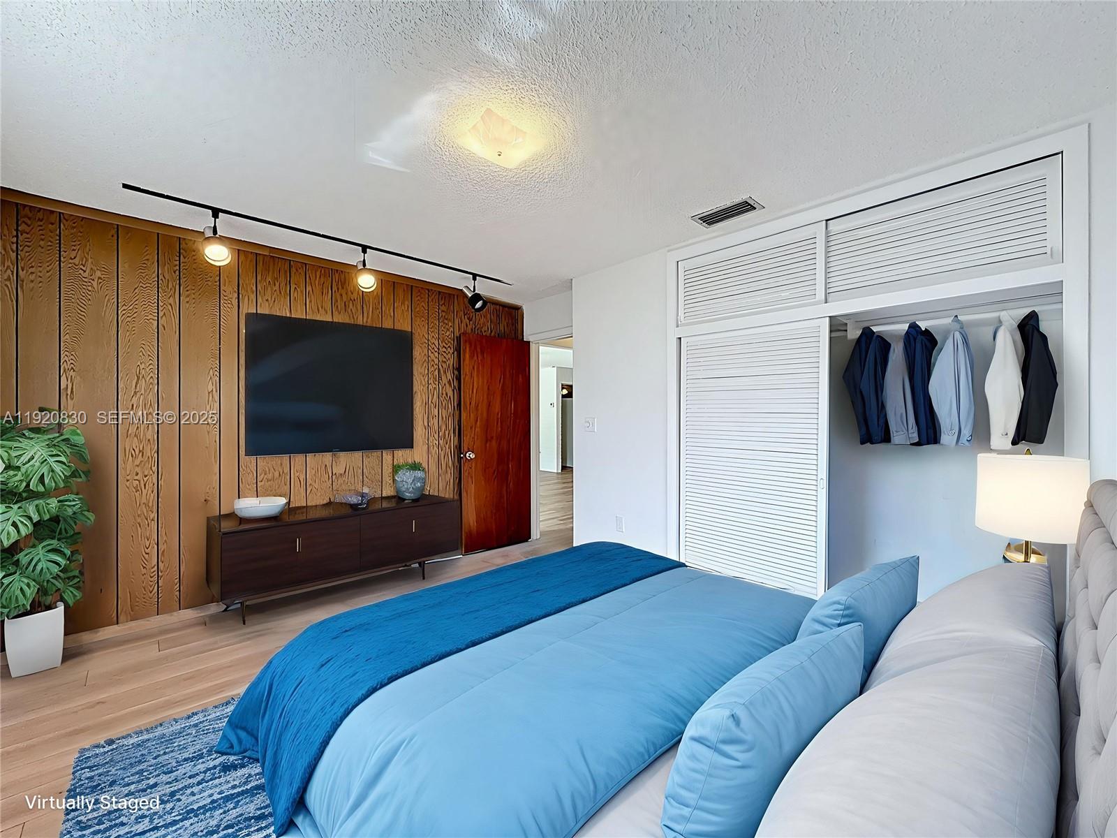 7541 Embassy Boulevard Miramar, FL 33023 - Photo 30 of 60 a bedroom with a bed and a flat screen tv