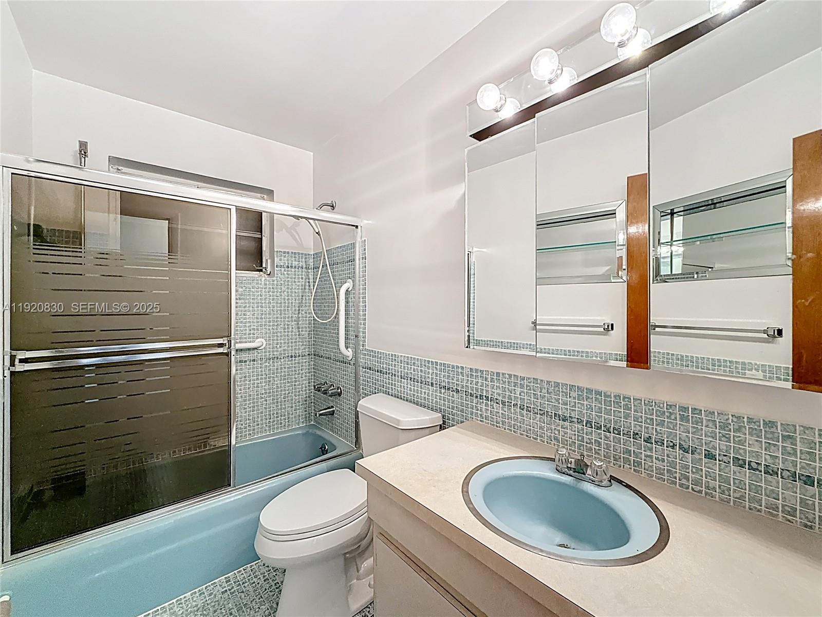 7541 Embassy Boulevard Miramar, FL 33023 - Photo 34 of 60 a bathroom with a granite countertop toilet sink and shower