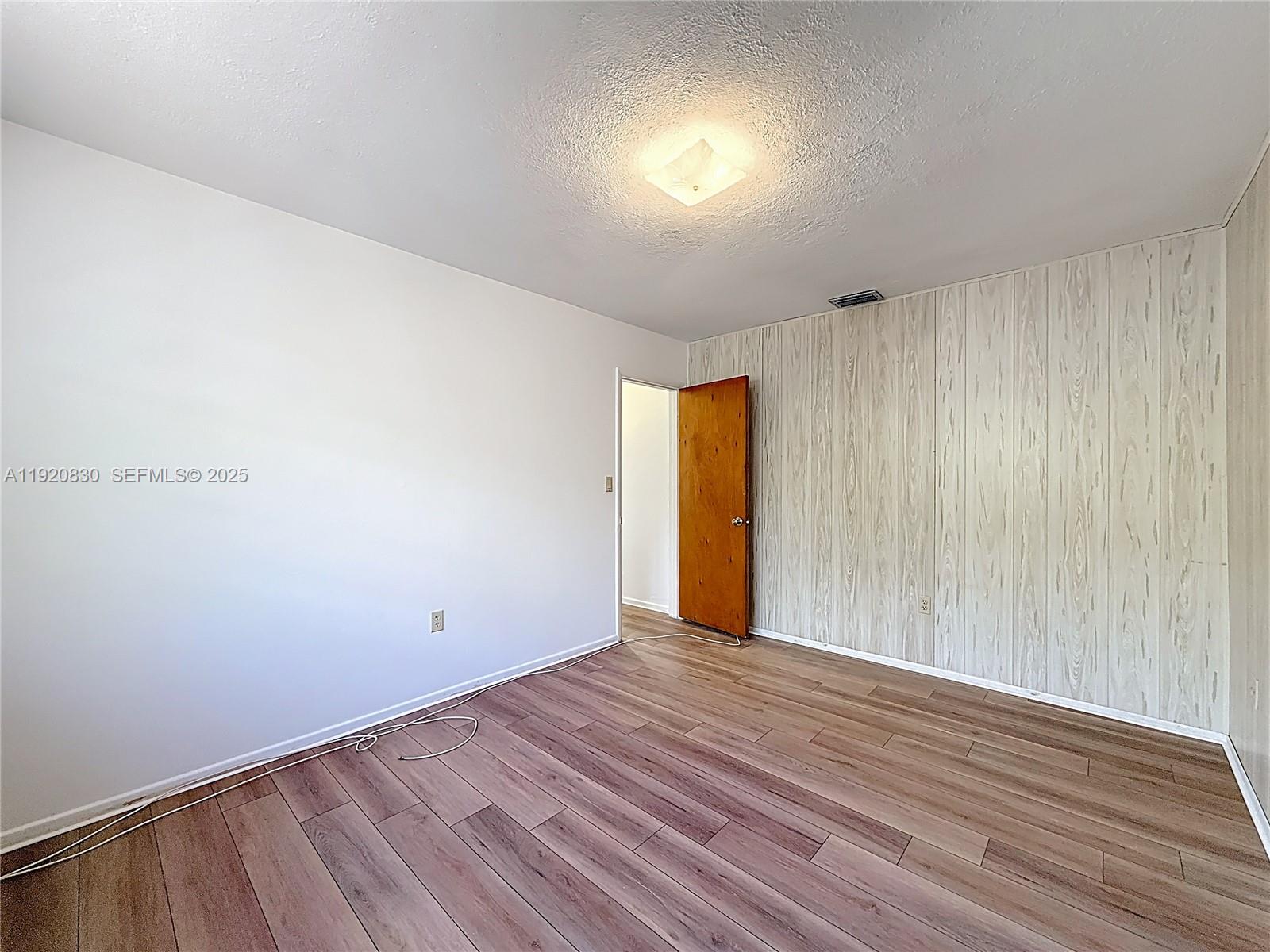 7541 Embassy Boulevard Miramar, FL 33023 - Photo 37 of 60 a view of an empty room with wooden floor