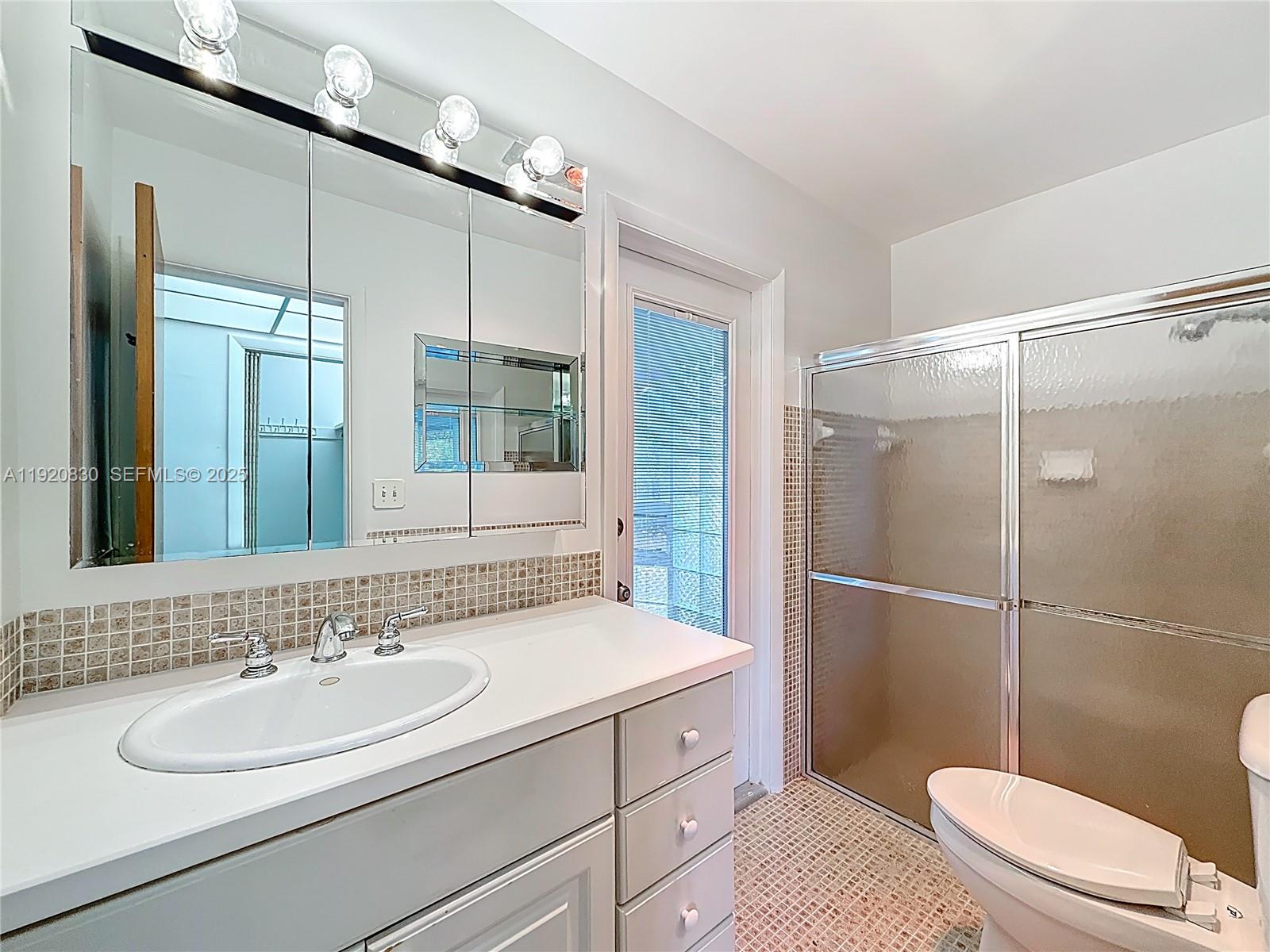 7541 Embassy Boulevard Miramar, FL 33023 - Photo 38 of 60 a bathroom with a sink a toilet and shower