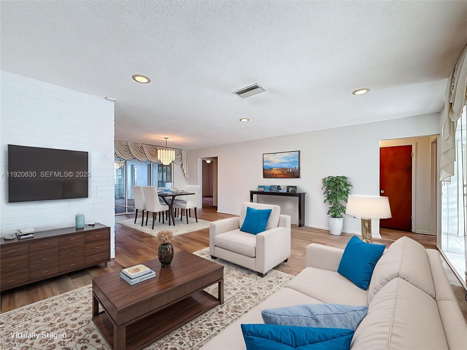 7541 Embassy Boulevard Miramar, FL 33023 - Photo 8 of 60 a living room with furniture a rug and a flat screen tv