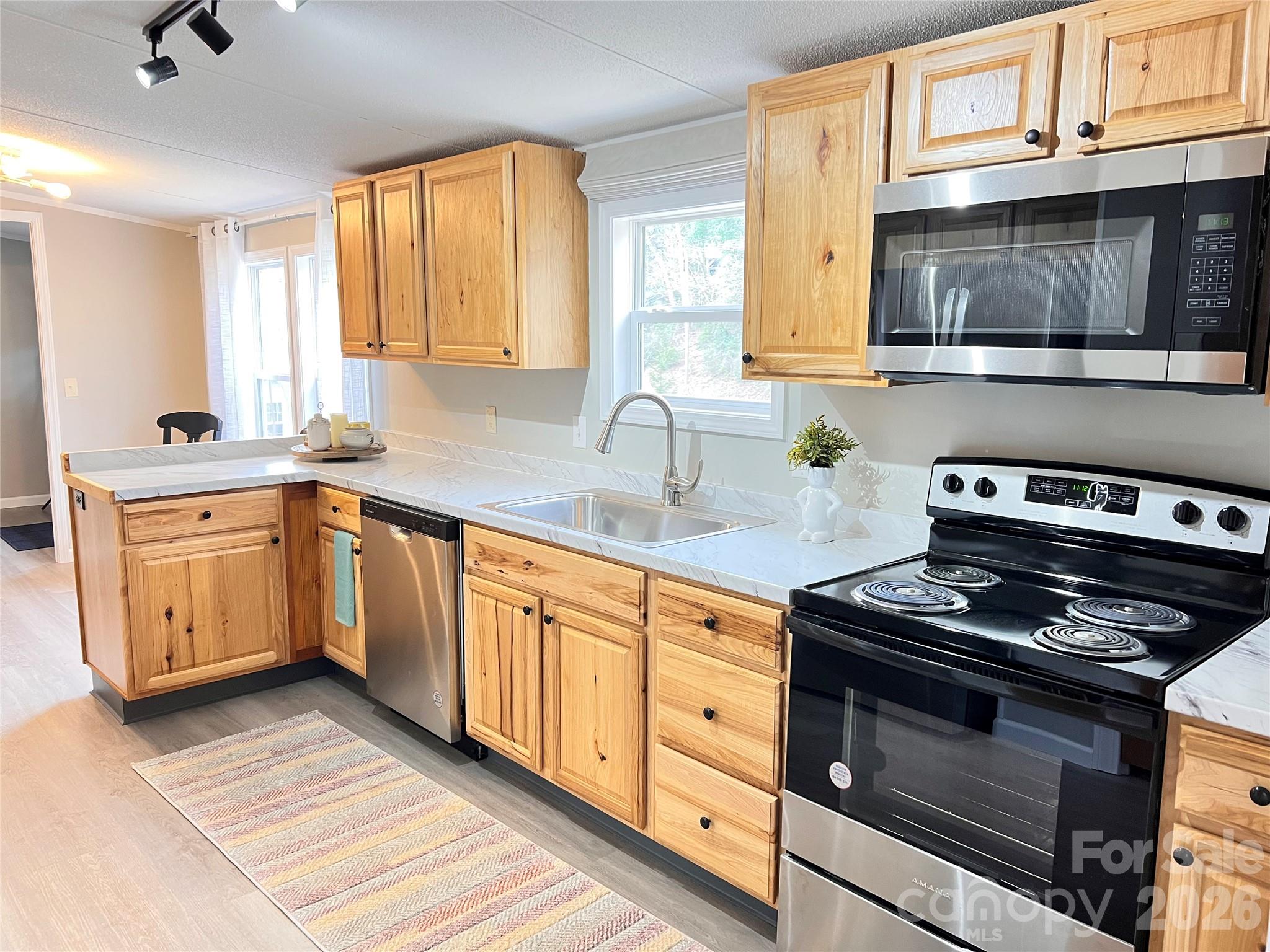 25 Overbrook Drive Saluda, NC 28773 - Photo 11 of 42 a kitchen with stainless steel appliances a stove sink and cabinets