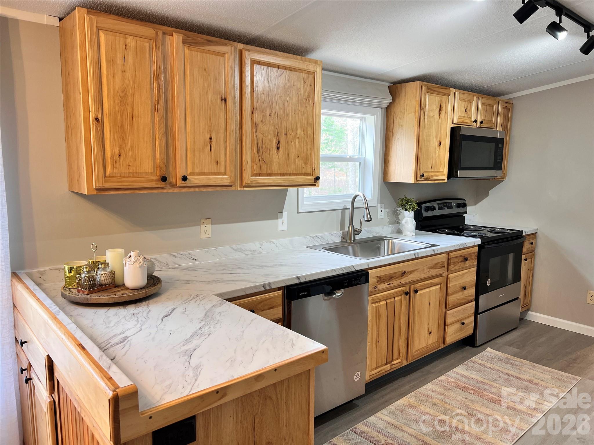 25 Overbrook Drive Saluda, NC 28773 - Photo 12 of 42 a kitchen with stainless steel appliances granite countertop a sink stove and cabinets