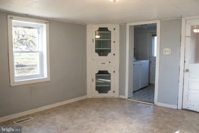 an empty room with windows and closet