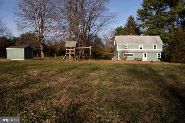 a view of a house with a yard and garage