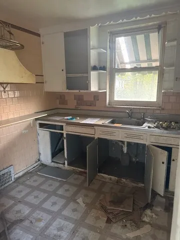 a kitchen with a sink stove and cabinets