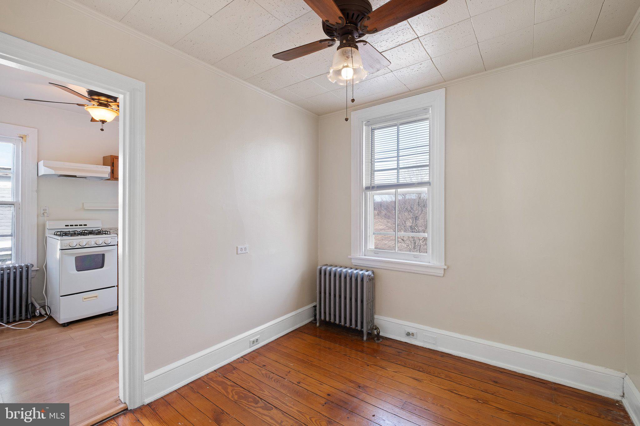 221 Chestnut Street New Castle, DE 19720 - Photo 14 of 25 a view of an empty room with a window and wooden floor