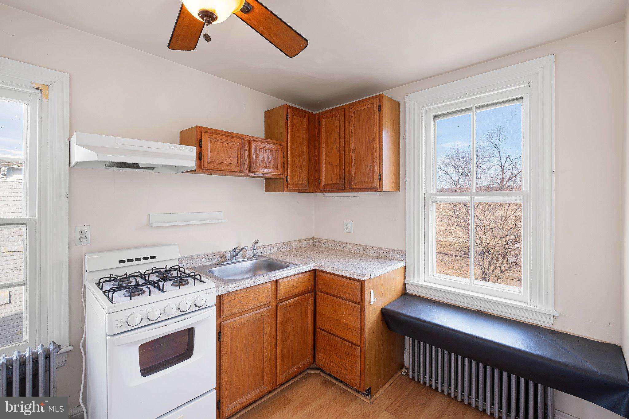 221 Chestnut Street New Castle, DE 19720 - Photo 16 of 25 a kitchen with stainless steel appliances granite countertop a stove a sink and a microwave