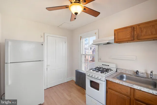 a kitchen with stainless steel appliances a stove a refrigerator and cabinets