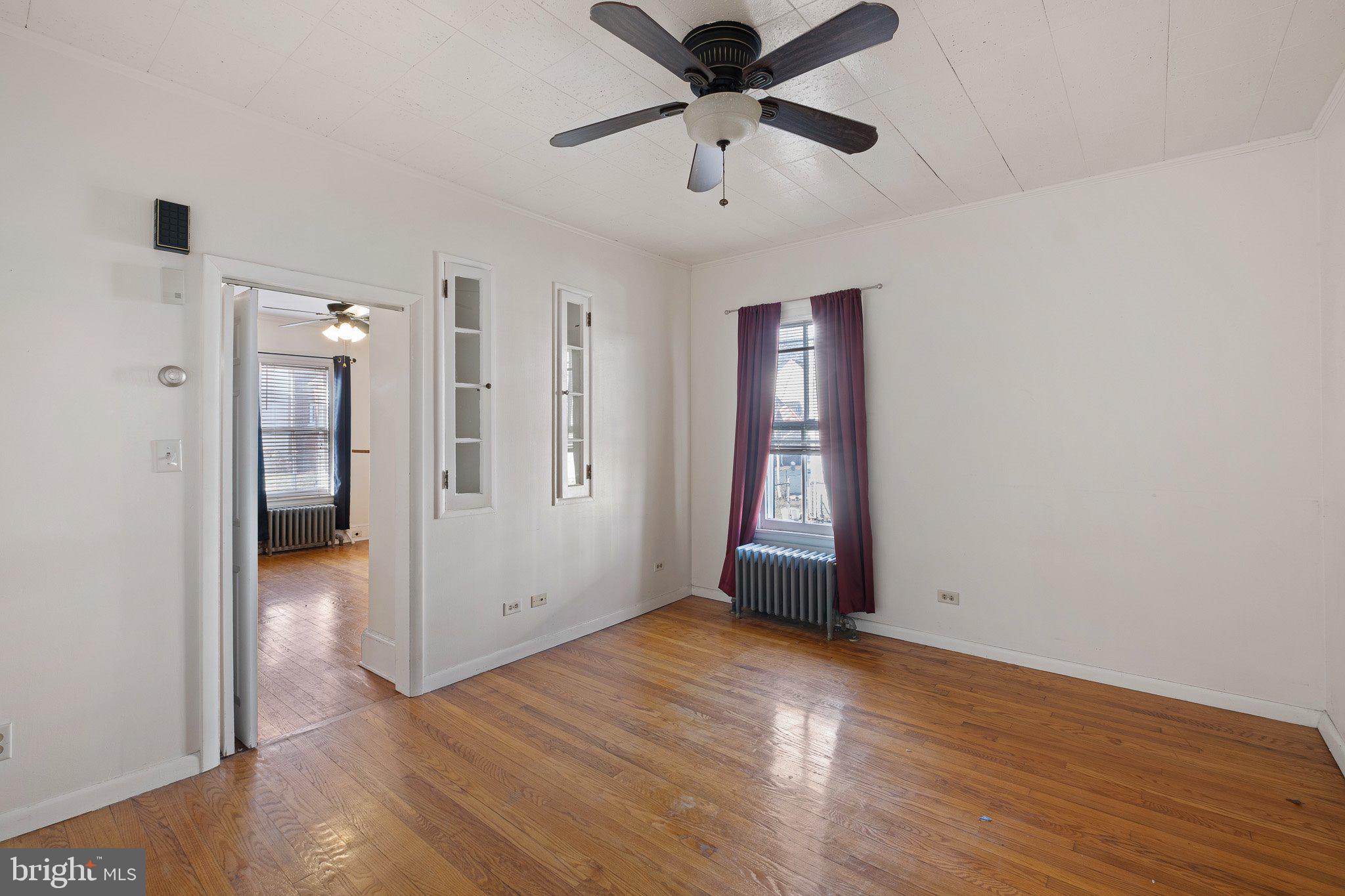221 Chestnut Street New Castle, DE 19720 - Photo 6 of 25 a view of an empty room with wooden floor and a window
