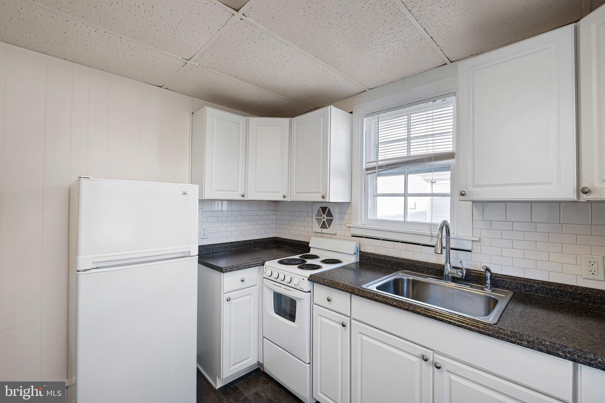 221 Chestnut Street New Castle, DE 19720 - Photo 8 of 25 a kitchen with a white cabinets and white appliances
