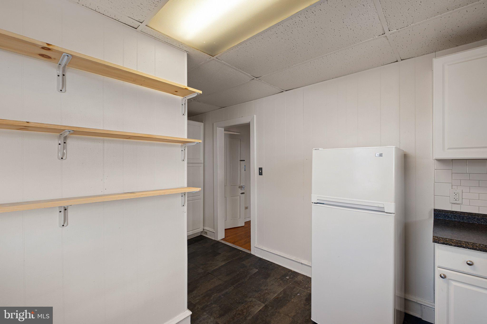 221 Chestnut Street New Castle, DE 19720 - Photo 9 of 25 a white refrigerator freezer and a stove sitting inside of a kitchen