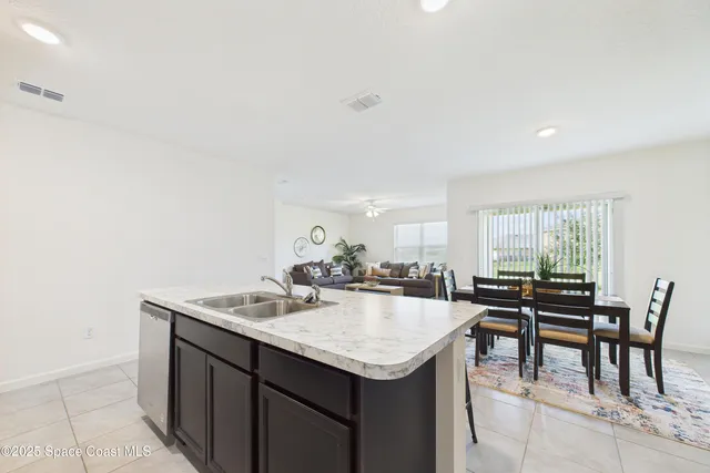 a dining room with a wooden table and chairs