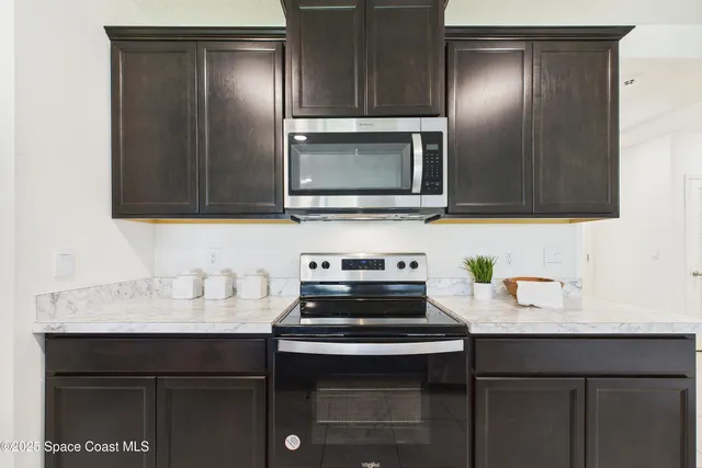 a living room with furniture a rug and a window