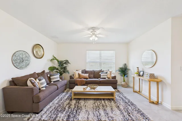a view of a livingroom with a ceiling fan and a window