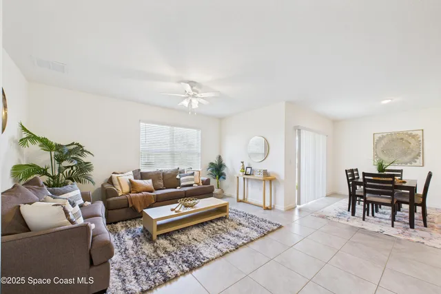 an empty room with a ceiling fan and a window