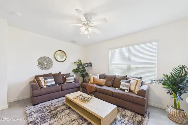 an empty room with a ceiling fan and a window