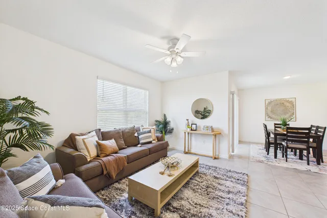an empty room with a ceiling fan and a window
