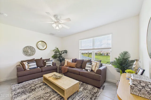an empty room with a ceiling fan and a window