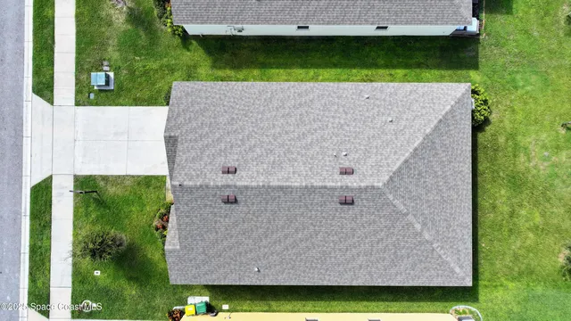 a kitchen with kitchen island granite countertop a sink and a refrigerator