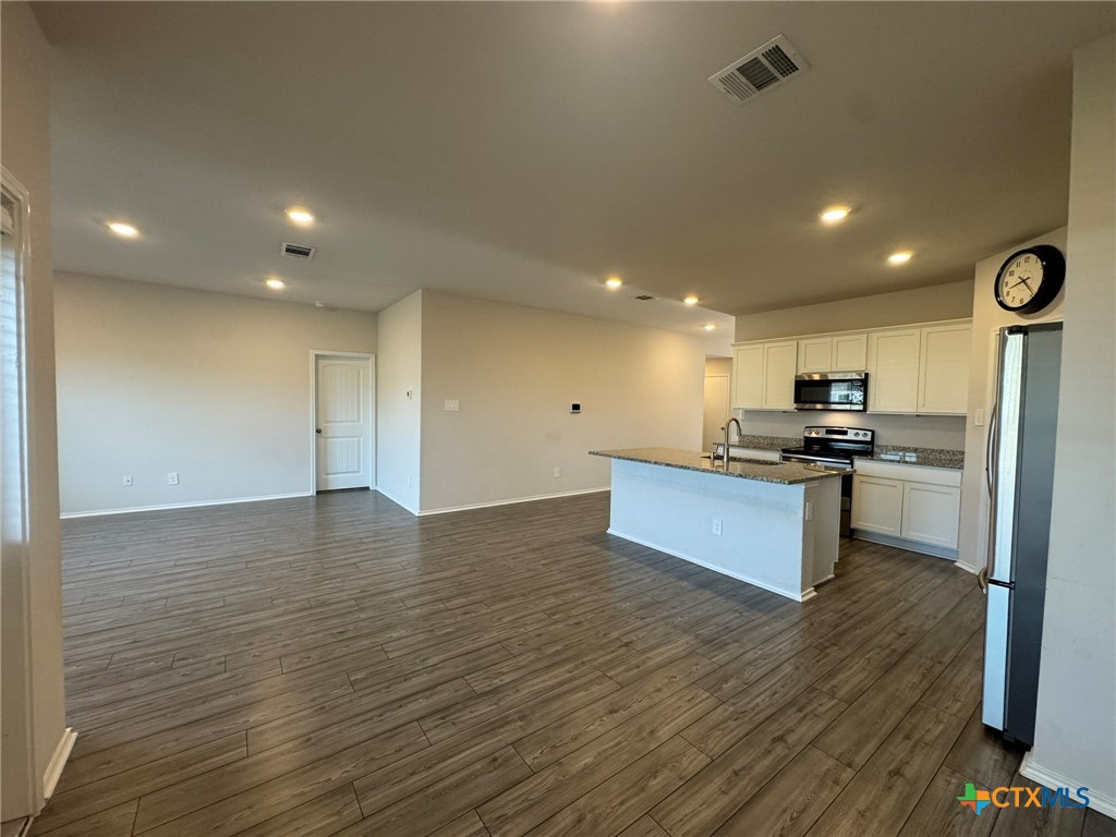 208 Ida Loop Seguin, TX 78155 - Photo 2 of 16 a view of kitchen with kitchen island stainless steel appliances sink refrigerator and microwave