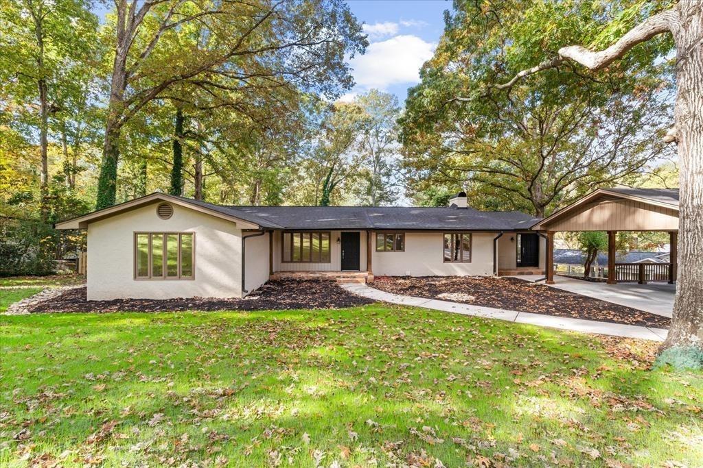 a house that has a tree in front of it