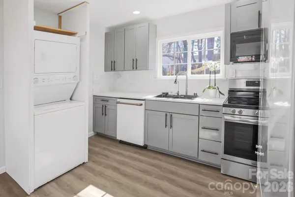 a kitchen with a stove oven and sink