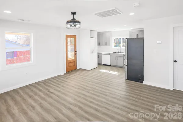 a view of a kitchen cabinets a wooden floor and a ceiling fan