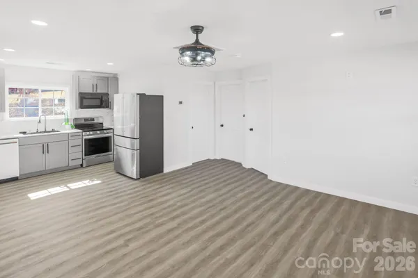a view of a kitchen with a stove cabinets and wooden floor