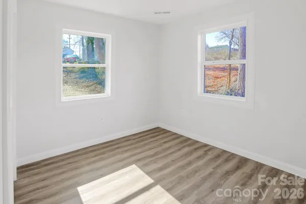 a view of room with window and hardwood floor