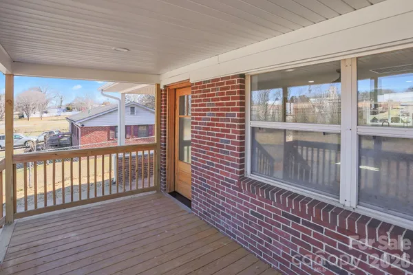 a view of a balcony with wooden floor