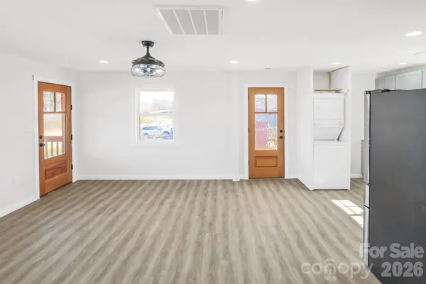 an empty room with windows and closet