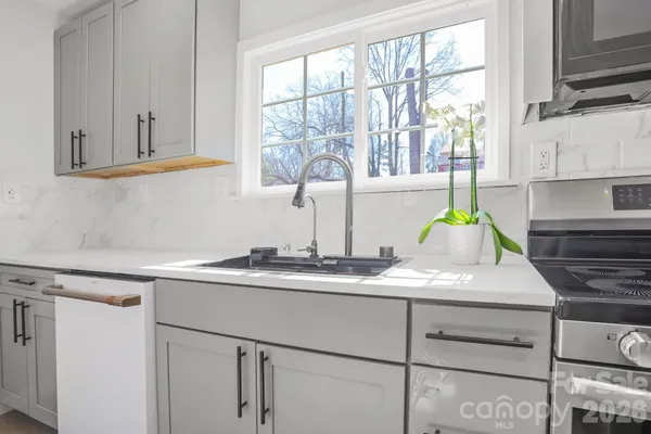 a kitchen with appliances cabinets and a window