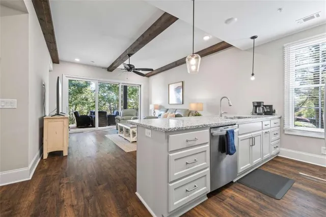 a kitchen with stainless steel appliances granite countertop a sink refrigerator and cabinets