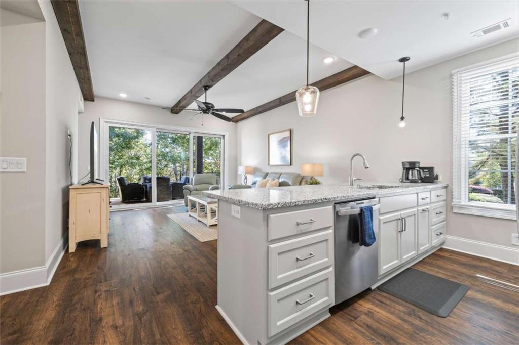 15 Cottage Lane, Unit 102 Toccoa, GA 30577 - Photo 18 of 40 a kitchen with granite countertop a stove cabinets and wooden floor