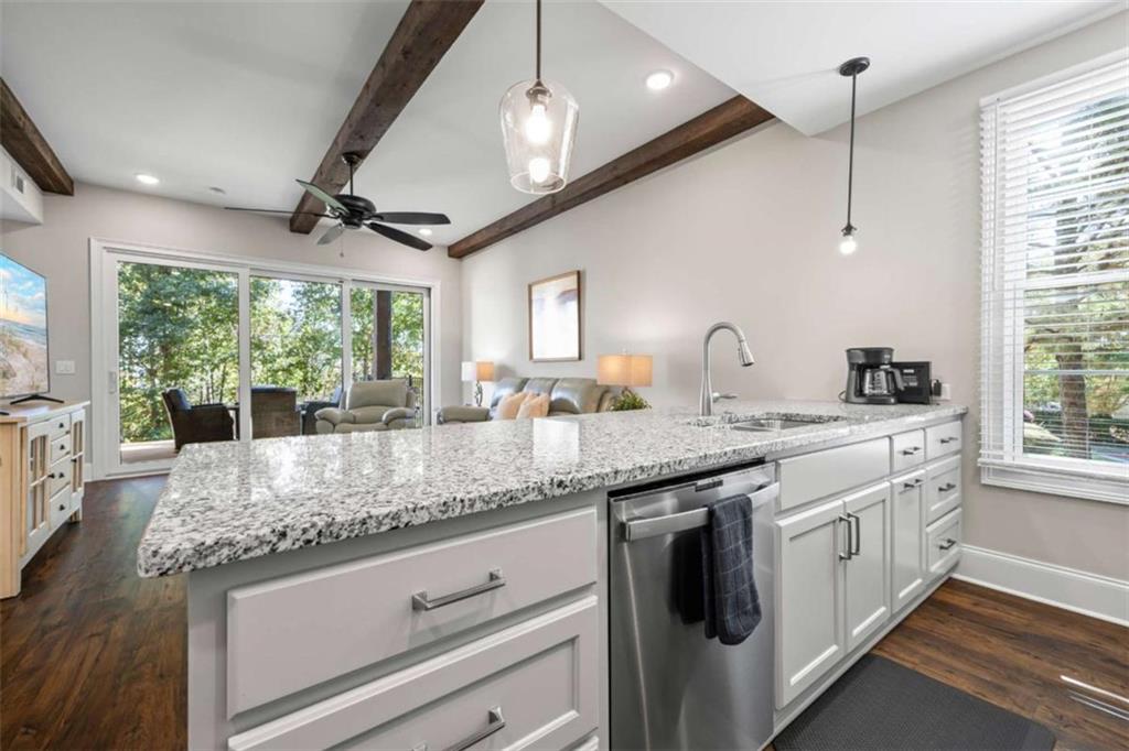 15 Cottage Lane, Unit 102 Toccoa, GA 30577 - Photo 21 of 40 a kitchen with stainless steel appliances granite countertop a sink a stove and a wooden floor