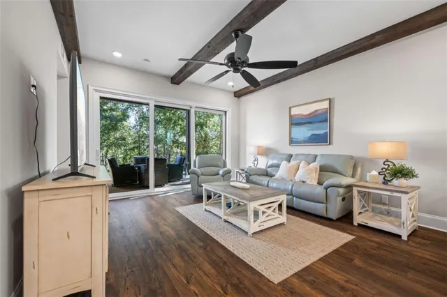 a living room with furniture and a ceiling fan