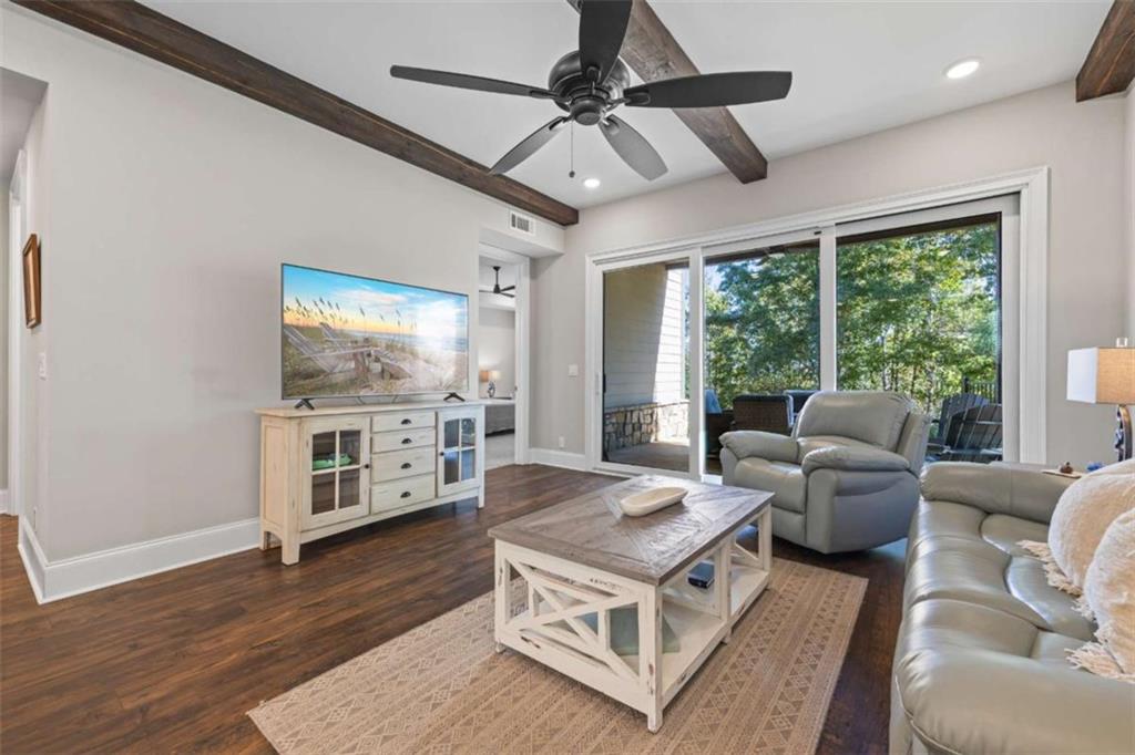 15 Cottage Lane, Unit 102 Toccoa, GA 30577 - Photo 27 of 40 a living room with furniture a flat screen tv and a floor to ceiling window