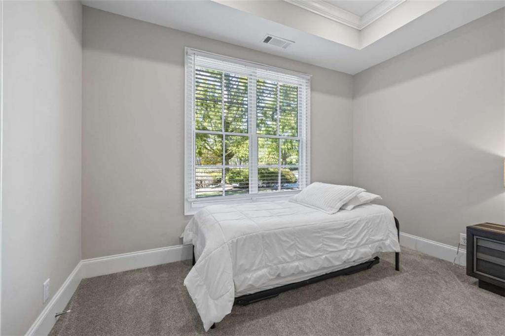 15 Cottage Lane, Unit 102 Toccoa, GA 30577 - Photo 31 of 40 a bed sitting in a bedroom next to a window