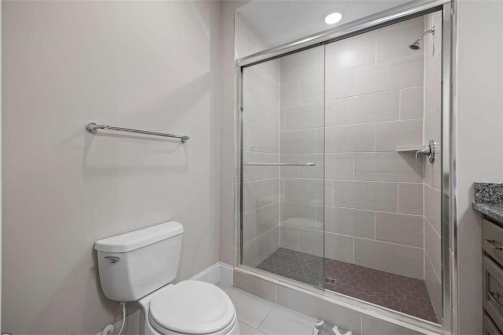 15 Cottage Lane, Unit 102 Toccoa, GA 30577 - Photo 32 of 40 a white toilet sitting next to a bathroom shower