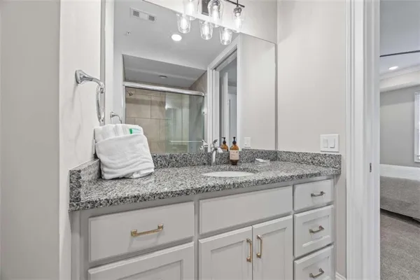 a bathroom with a glass shower door