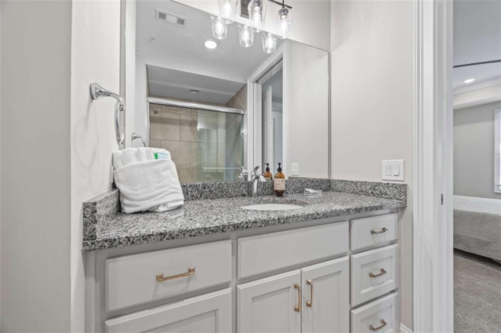 15 Cottage Lane, Unit 102 Toccoa, GA 30577 - Photo 35 of 40 a bathroom with a granite countertop sink and a mirror