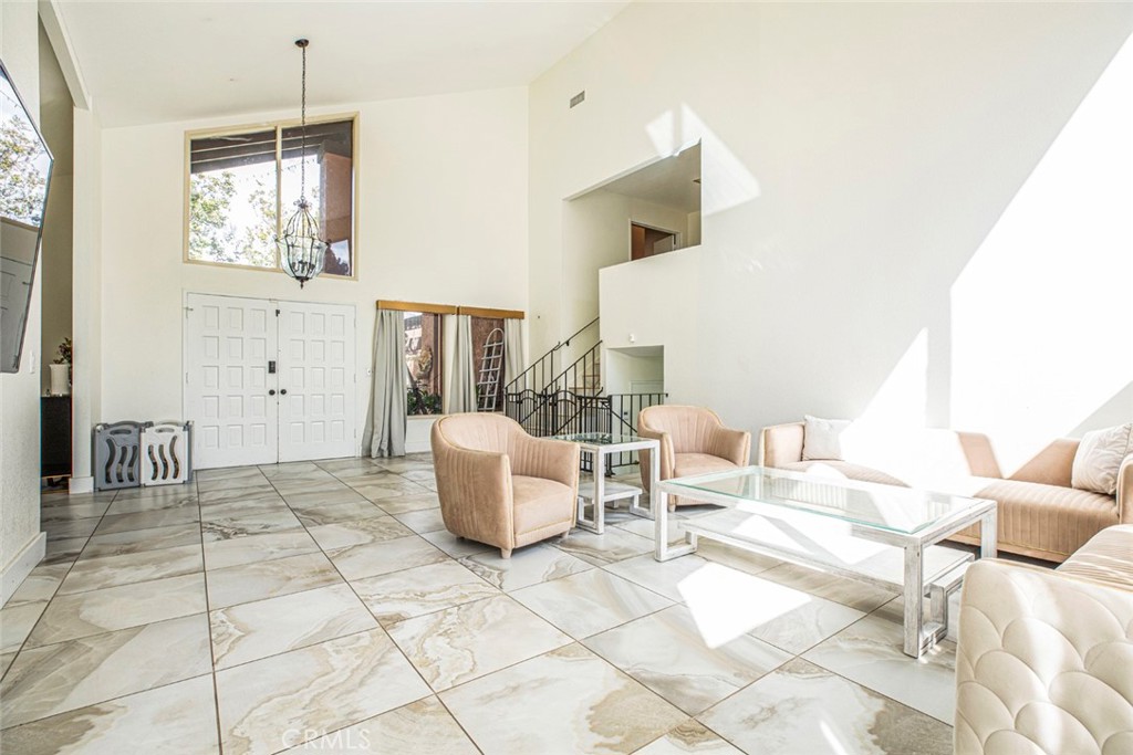18810 Kirkcolm Lane Porter Ranch, CA 91326 - Photo 13 of 75 a living room with couches and kitchen view with wooden floor