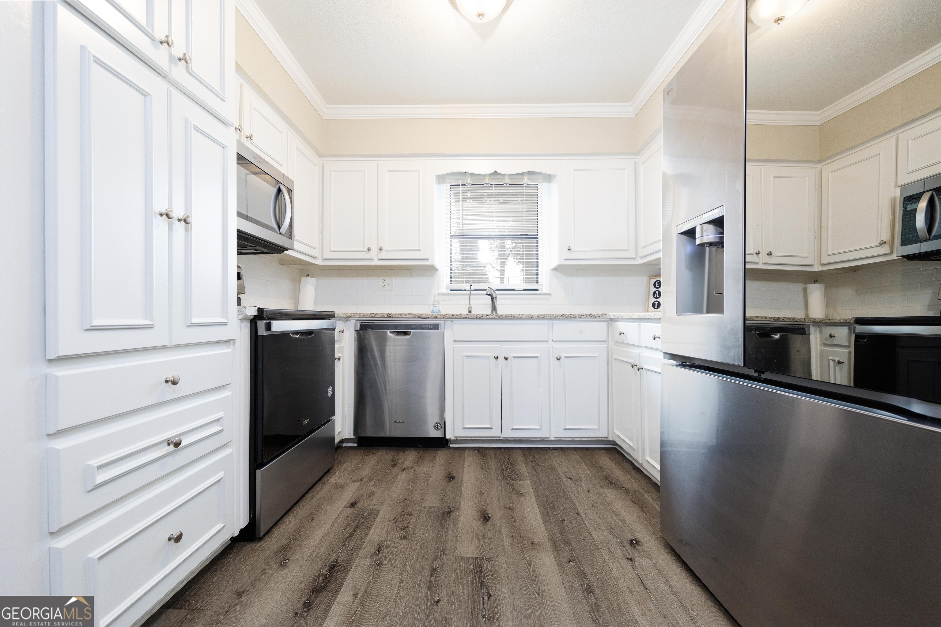 3 Primrose Court Columbus, GA 31907 - Photo 11 of 25 a kitchen with stainless steel appliances a sink cabinets and wooden floor