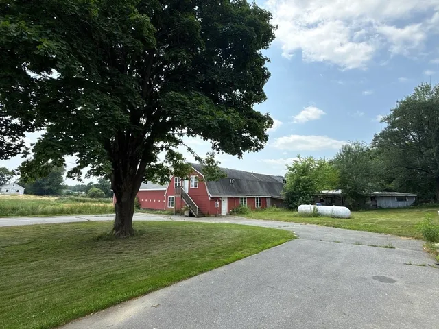 a view of yard with swimming pool and green space