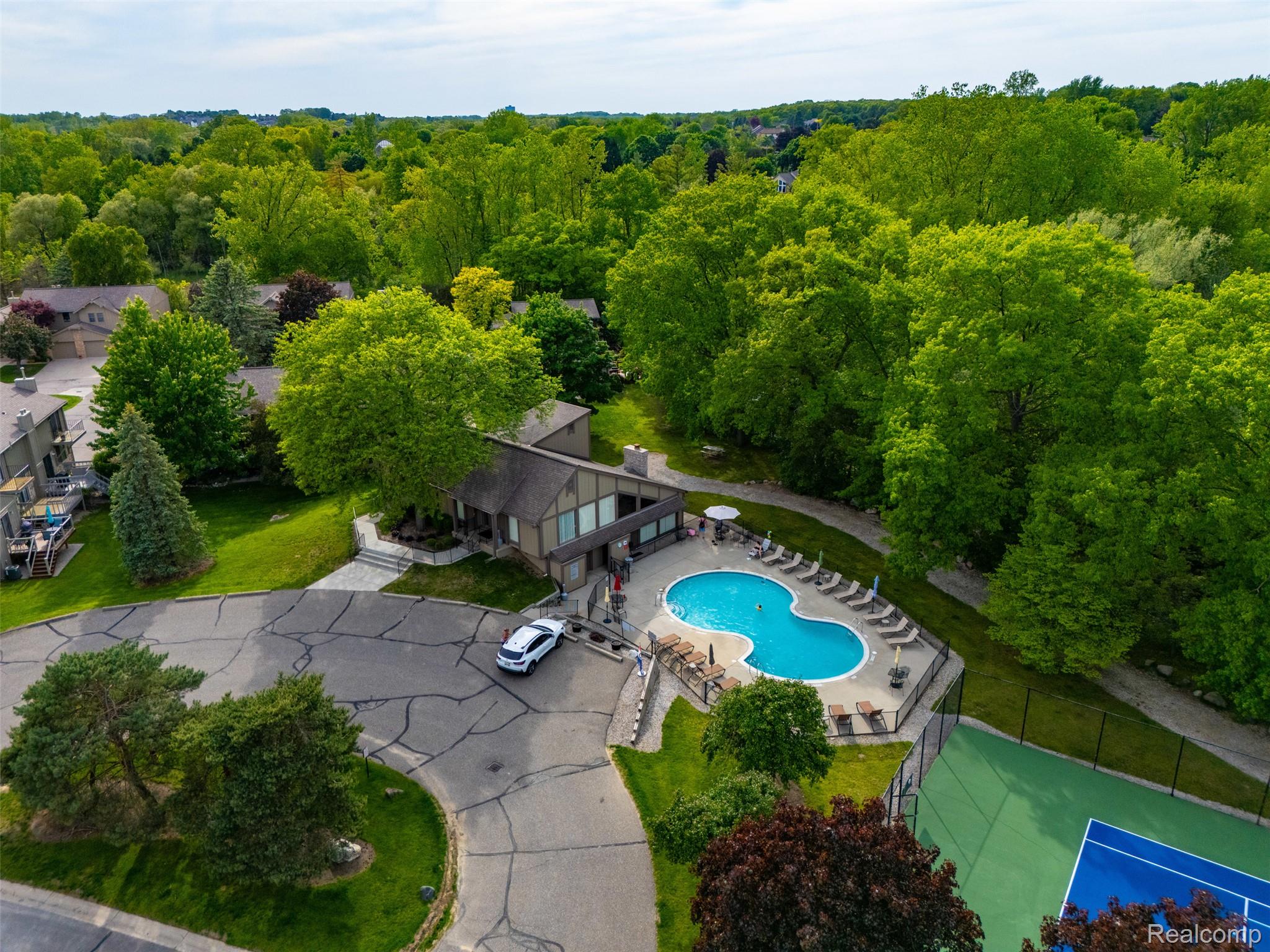 1687 Lodge Pole Lane Rochester, MI 48309 - Photo 47 of 53 Clubhouse with an outdoor swimming pool and adjacent tennis court