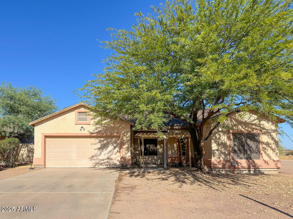15220 Padres Road Arizona City, AZ 85123 - Photo 1 of 16 a house with a tree in front of it